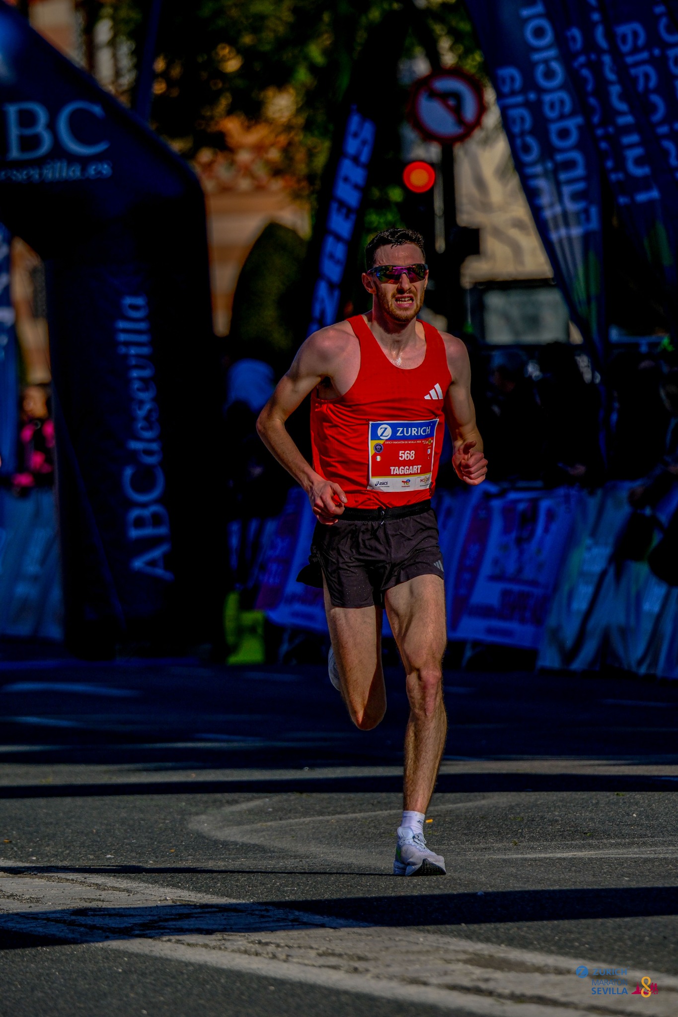Eoin Taggart running the Seville Marathon in a red racing vest